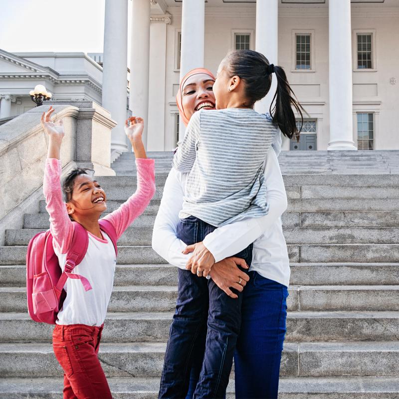 Family celebrating on steps of the courthouse