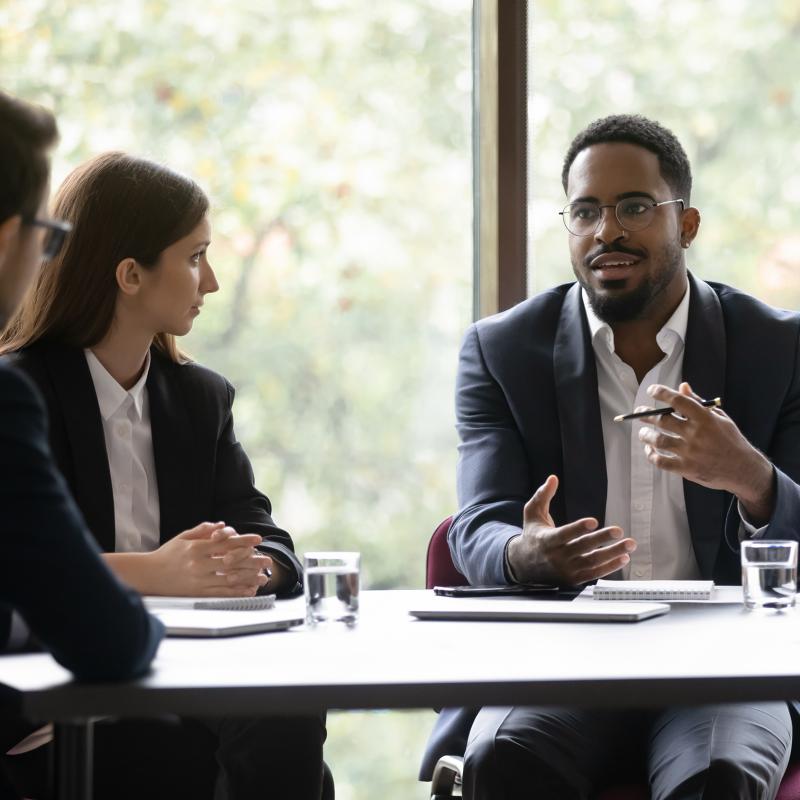 Team members meeting at conference room table